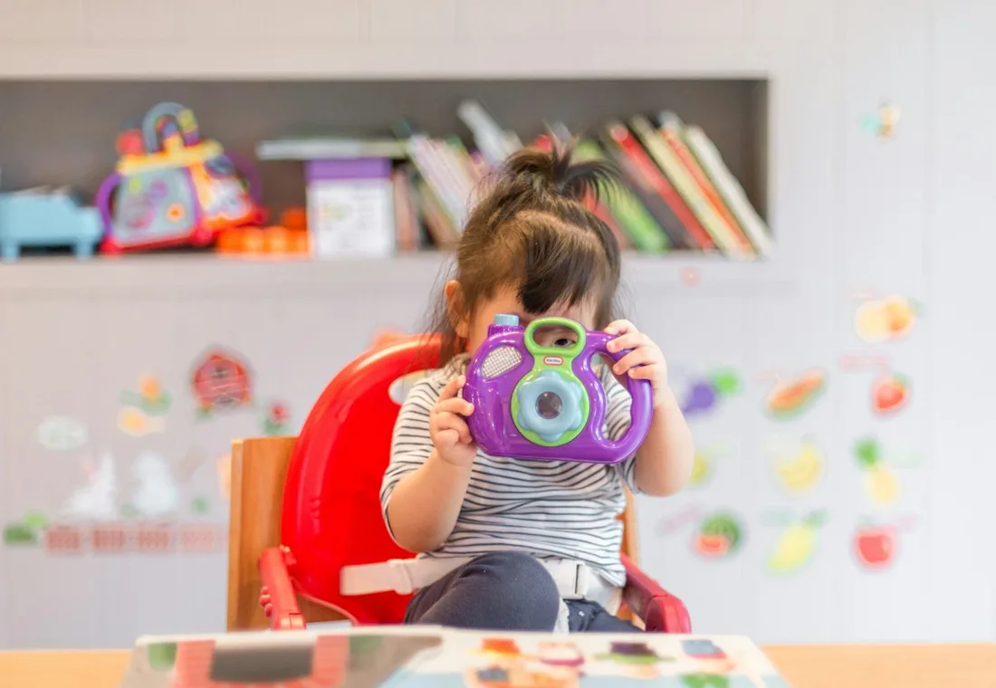 Parent holding a toddler in a calm clinic waiting area at Nareddy Care Hospitals